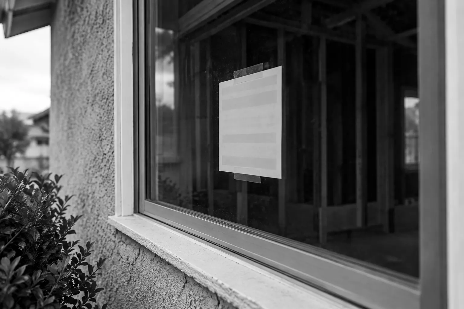 Render of a building permit card taped inside a house window during a kitchen remodel.
